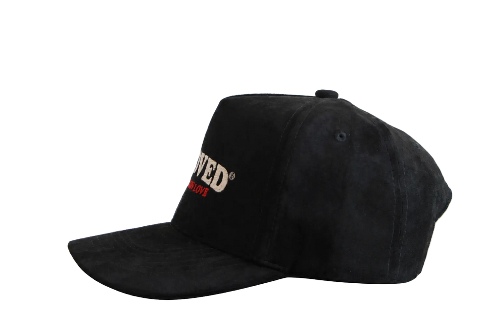 Beloved by Kameron Love black suede cap with red trim, side view